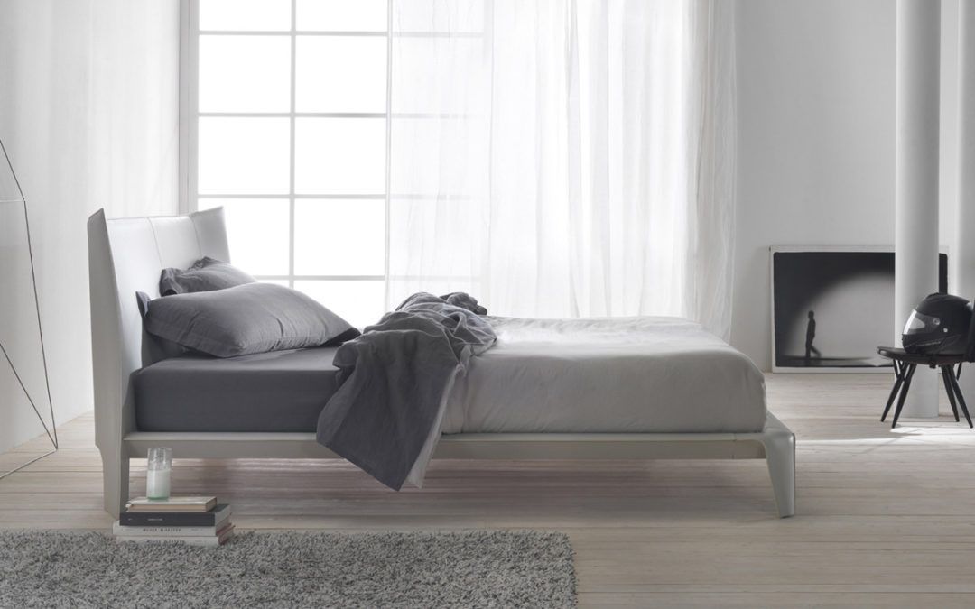 Una Cama con Esencia Minimalista para Dormitorios Actuales